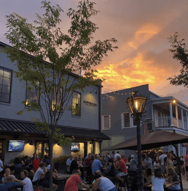 Illuminated restaurant exterior signs and outdoor patio signage example at evening in metro Atlanta downtown district