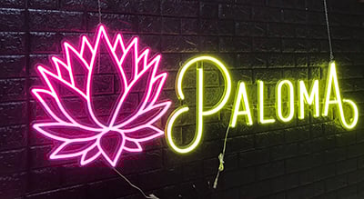 Pink lotus flower and yellow Paloma text in custom LED neon wall sign installed in Marietta Georgia.
