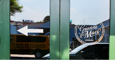 Gianni and Mac’s restaurant window decals with logo and directional entrance arrow in Marietta Square, GA.