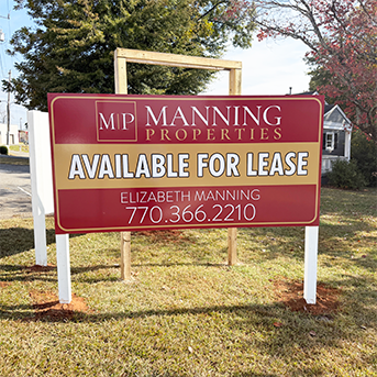 Available for lease sign by Manning Properties with contact for Elizabeth Manning, installed by Marietta Signs in Marietta, GA.