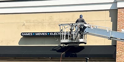 Marietta Signs rebranding Mega Replay to Disc Replay with updated signage. Removal of the original name before the new sign is added.
