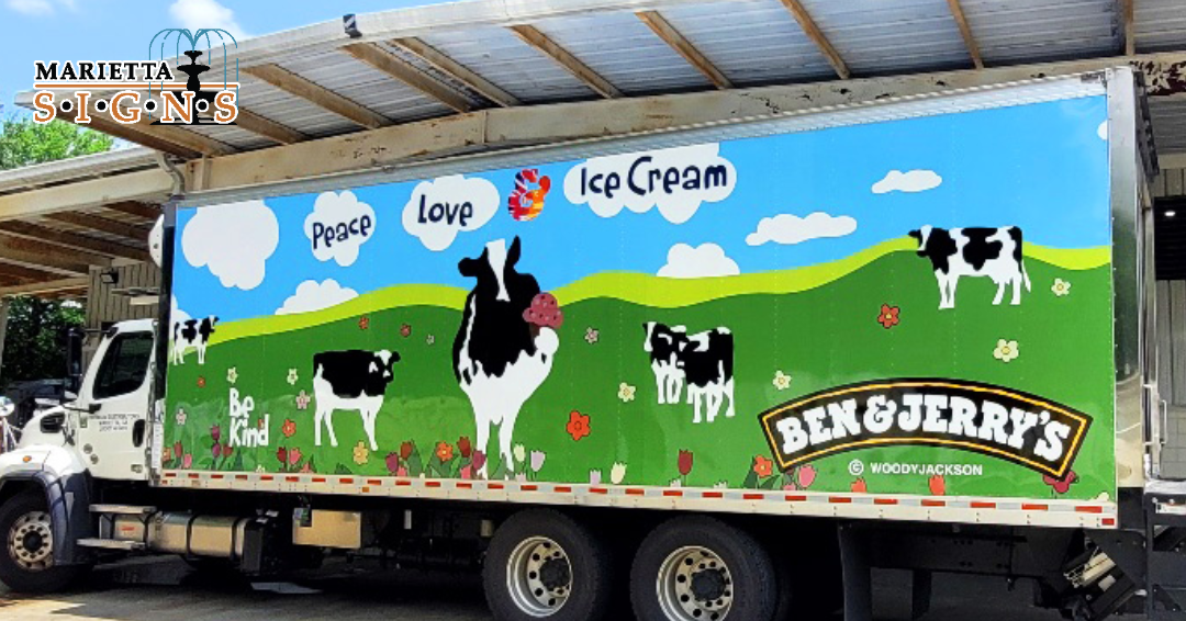 Completed Ben and Jerry's delivery truck wrap for Premium Distributors, featuring colorful full-coverage fleet graphics with cows, rolling hills, and branded artwork installed by Marietta Signs.